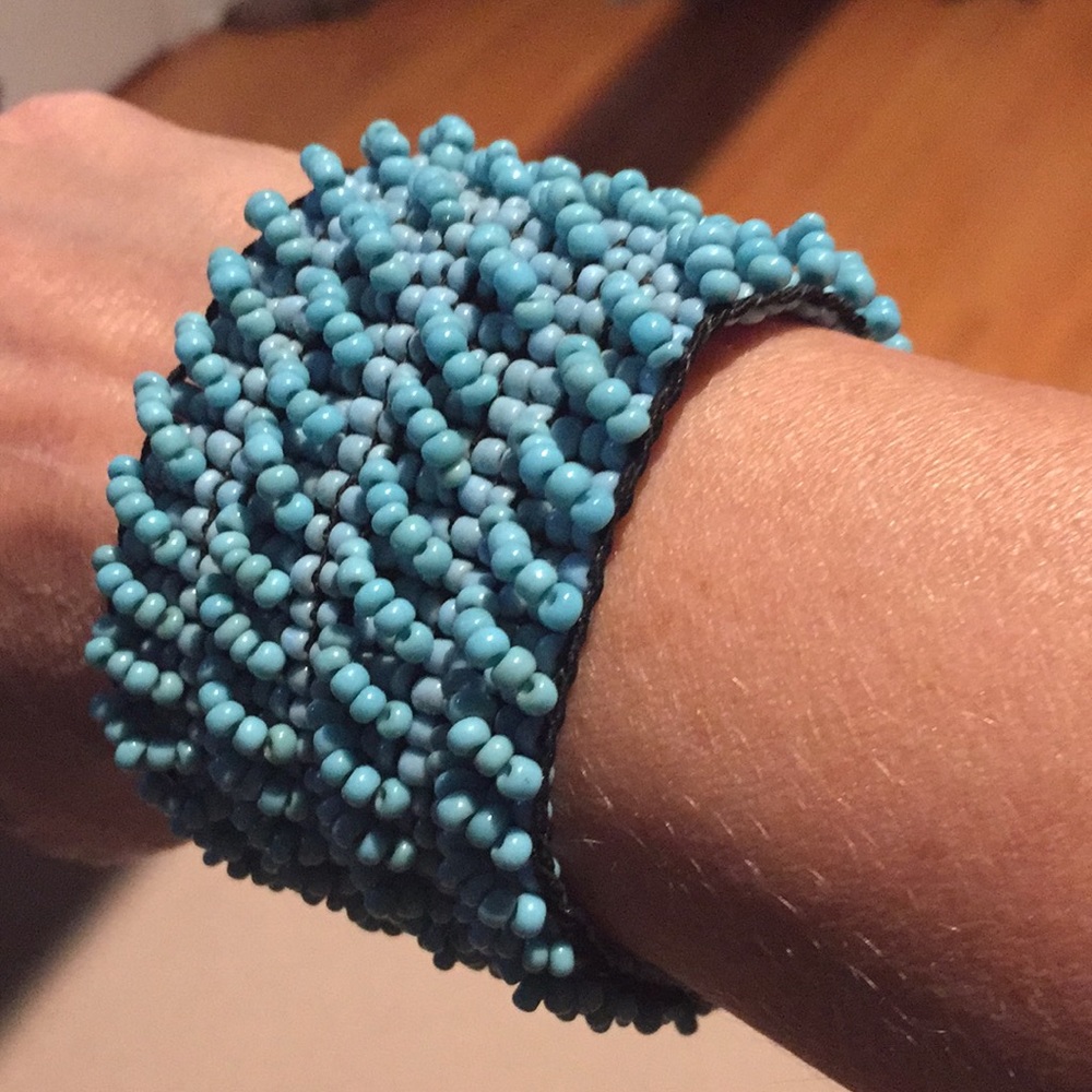 Turquoise beaded bracelet with wooden clasp.
